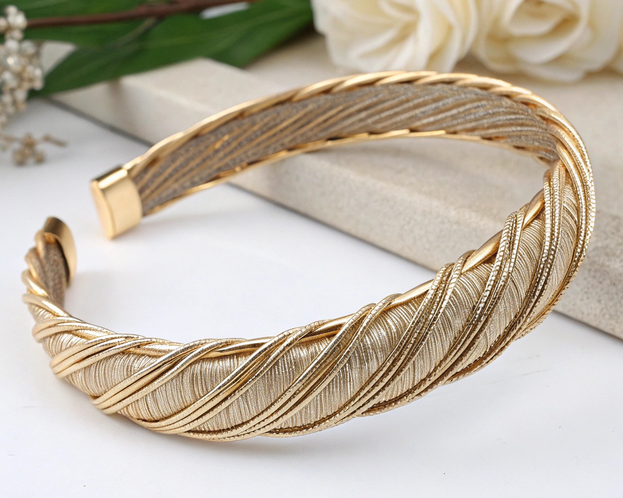 Preparing the headband's foundation involves wrapping it with metallic wire or ribbon to create an elegant base.
